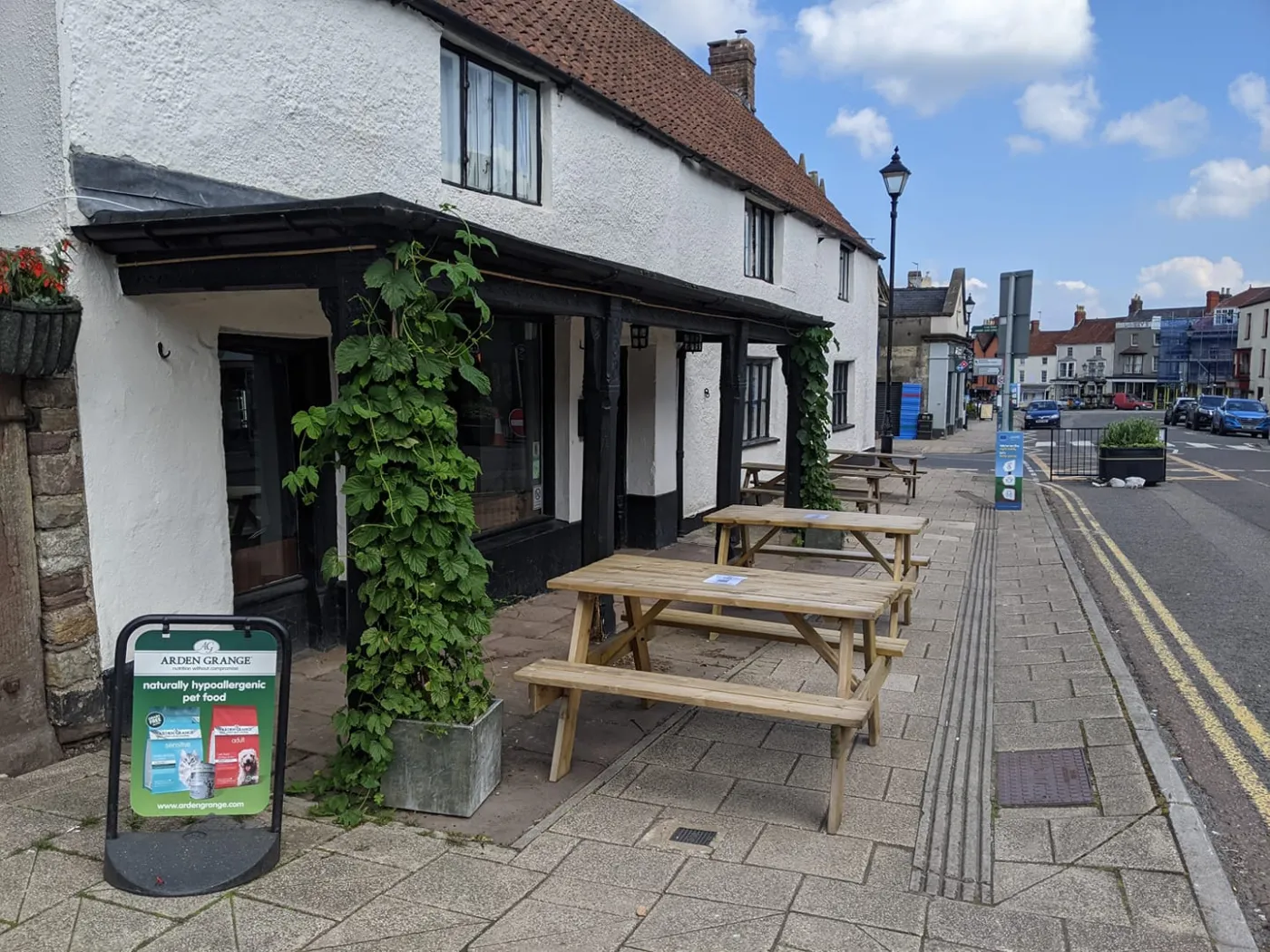 Outdoor tables beside The Butcher’s Hook on Thornbury High Street